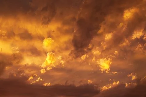Orange sunset on sky with clouds. Sun in the evening heaven Stock Photos