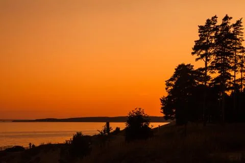 The orange sunset sky on the wide river Stock Photos