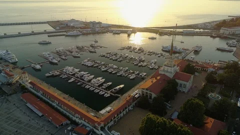 Orange sunset sun Sochi cityscape downtown marina station spire star pier yacht  Stock Footage 122018680