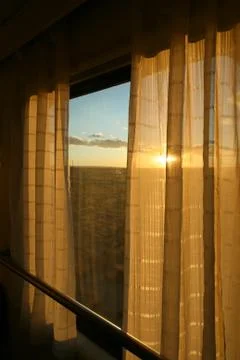 Orange sunset through the window and curtain on the train Foto stock