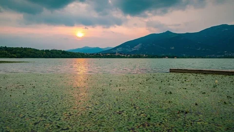 Orange sunset time lapse over the lake in summer - Lake of Oggiono Lombardy Video stock 93299594