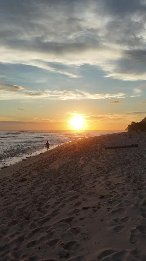 Orange sunset with yellow and red tints over the ocean and sandy coast Stock Footage 281539582