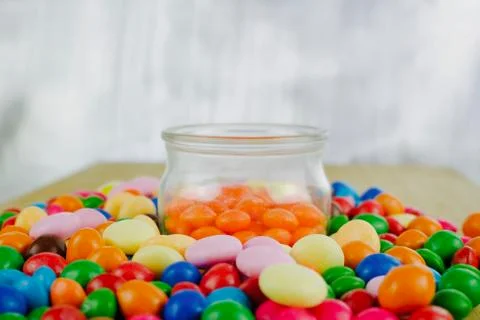 Orange sweets in jar Stock Photos