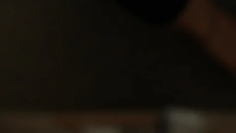 Orange tabby house cat inside a cardboard box peeking out the "door" flap. Stock-Footage 88417902