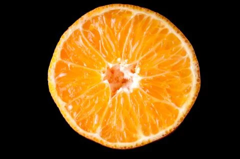 Orange tangerine fruit half slice isolated on black background Stock Photos