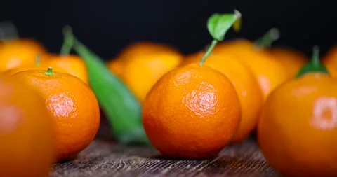 Orange tangerines stacked together, a large number of ripe orange tangerines on Stock Footage 318214310