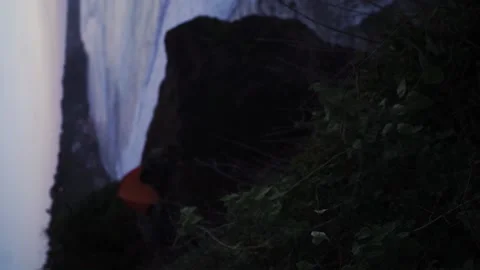 Orange tent on the edge of the cliff. (vertical video) Stock Footage 154159989