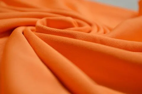 Orange textile pattern as a background. Orange material texture on fabric Foto stock