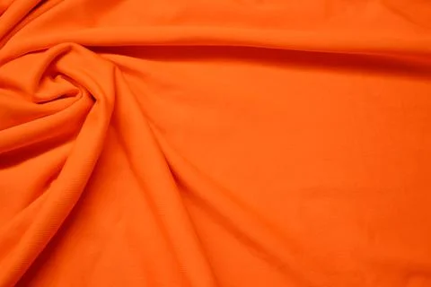 Orange textile pattern as a background. Orange material texture on fabric Stock Photos