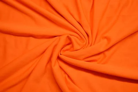 Orange textile pattern as a background. Orange material texture on fabric Stock Photos