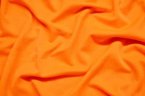 Orange textile pattern as a background. Orange material texture on fabric Stock Photos