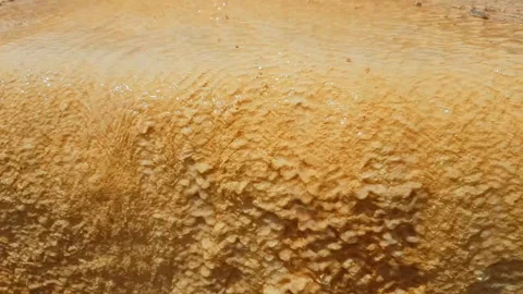 Orange texture on a mineral spring in the mountains, stone deposits as a Stock Footage 118587968