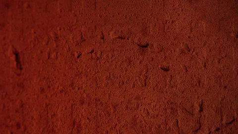 Orange textured background with a flickering fire reflection, creating a wa.. Stock Footage 310234768