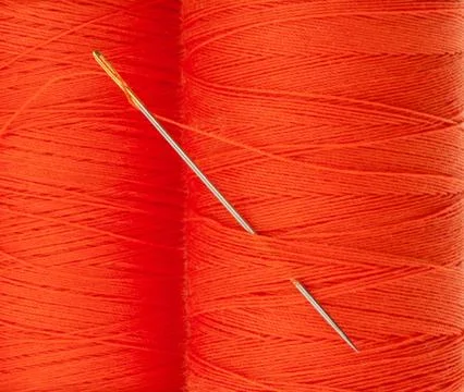 Orange thread with needle Stock Photos