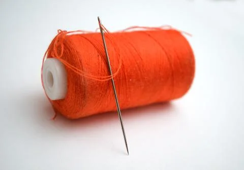 The orange thread with a needle 写真素材
