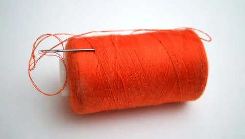The orange thread with a needle 写真素材