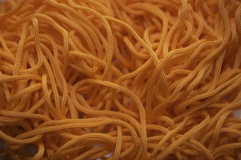 Orange thread on a white background close-up Stock Photos