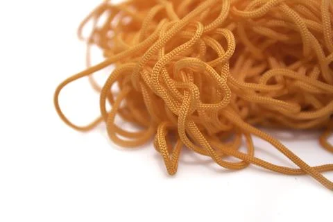 Orange thread on a white background close-up Stock Photos