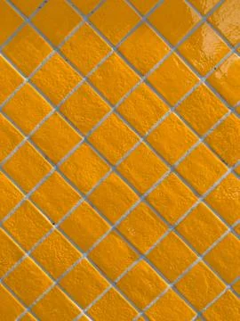 Orange tiled wall pattern with textured glazed surface Foto stock