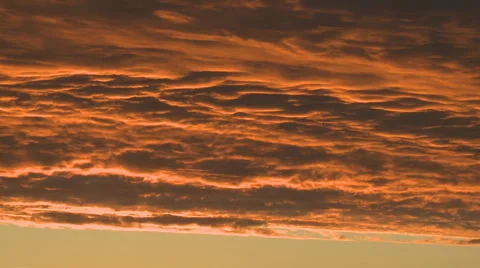Orange tipped clouds at sunset Vídeo Stock 3971564