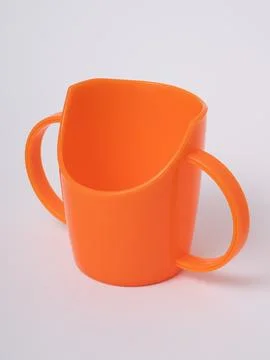 Orange toddler cup diagonal view Stock Photos