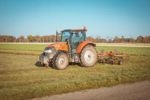 Orange Tractor with Blue Sky in Drenthe, the Netherlands Stock Photos