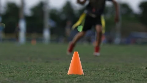An orange training cone on a field during flag football practice Stock Footage 90639977