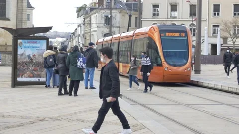 Orange tram leaving tramway stop at  Le Mans, Sarthe, Pays de la Loire region, Stock Footage 147516880