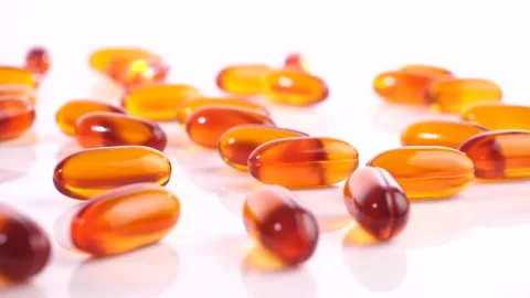 Orange transparent Capsules isolated on white Background Stock Footage 220938590