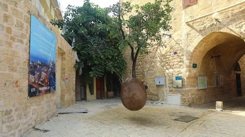 Orange tree in stone vessel hanging in the air in the Jaffa Old City. Stock Footage 82468556