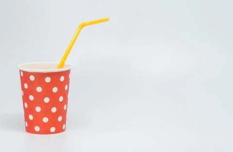 Orange tube in White dot pattern on red paper cup with white background Stock Photos