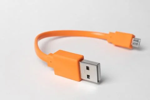 Orange USB micro-usb cabel isolated on grey background Stock Photos