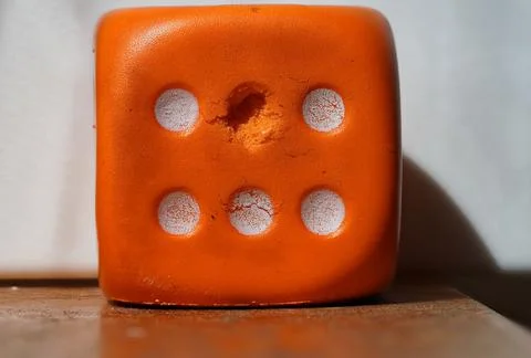 Orange used dice Stock Photos