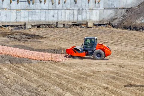 Orange vibratory roller compactor Stock Photos