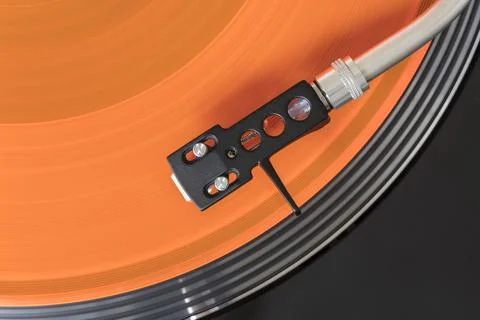 Orange Vinyl on recordplayer Stock Photos