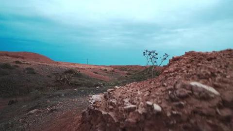 Orange volcanic desert under cloudy sky Stock Footage 318790025