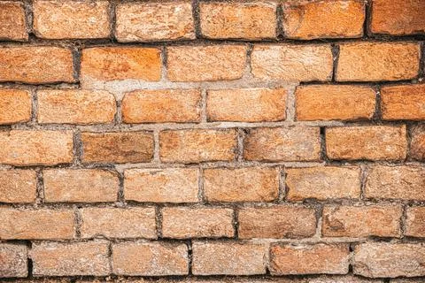 Orange wall of bricks. Close-up view of an aged brick wall. Construction ba.. Stock Photos