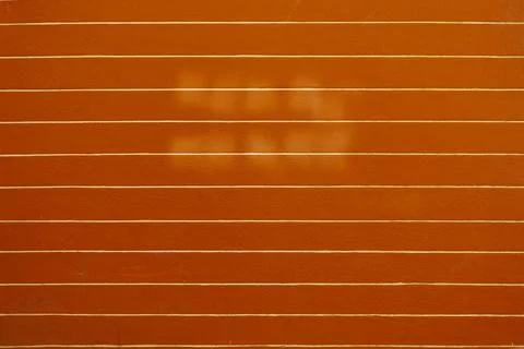 Orange wall with horizontal white lines and subtle light shadows Stock Photos