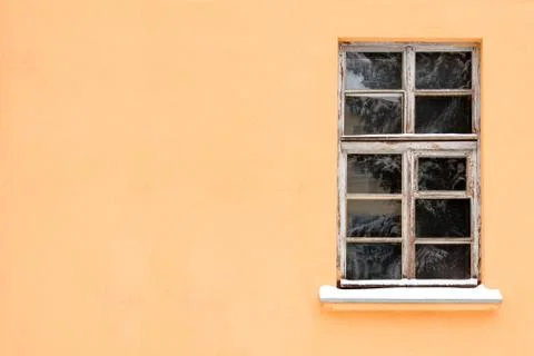 Orange wall with one old window Stock Photos