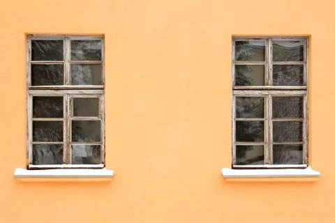 Orange wall with two old windows Stock Photos