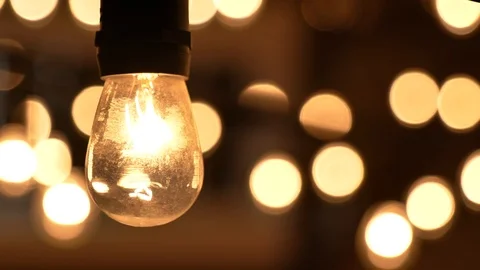 Orange warm lightbulb close up with bokeh lights move Video stock 120303889