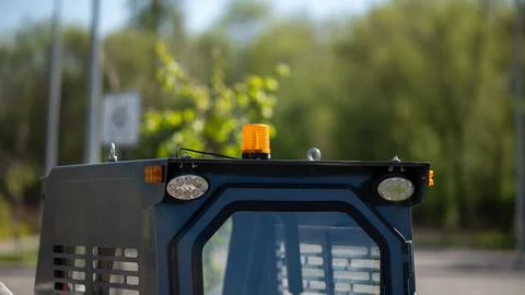 Orange warning beacon on top of construction vehicle Stock Photos