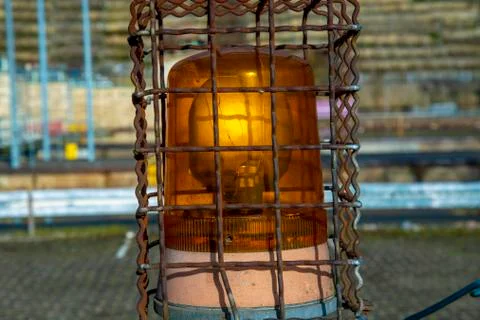 Orange warning light behind a safety fence Stock-Fotos