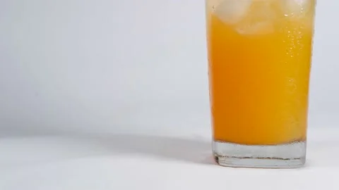 Orange water in a glass Stock Footage 228874171