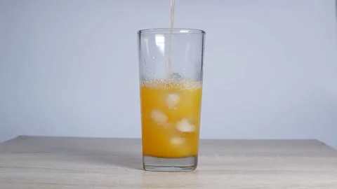 Orange water in a glass Stock Footage 228874388
