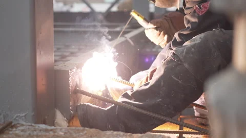 Orange welding arc lights up iron surface with intensity Stock Footage 313833769
