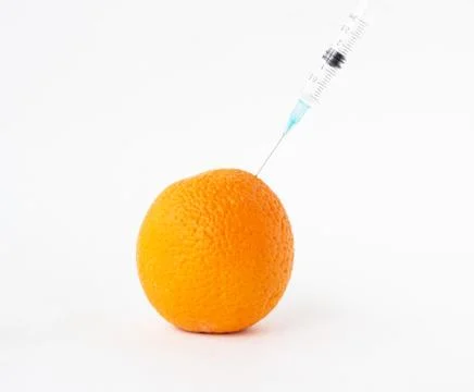 Orange on a white background in which enter gmo and nitrates, close-up Photos