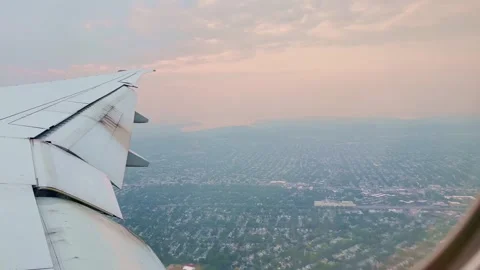 Orange wildfires smoke as viewed over NYC from an airplane window Stock Footage 243375742