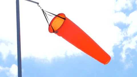 Orange wind sock indicator, blue sky and clouds Stock Footage 282594812