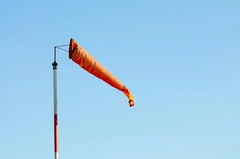 An Orange Windsock or Windvane Against the Blue Sky Stock Photos